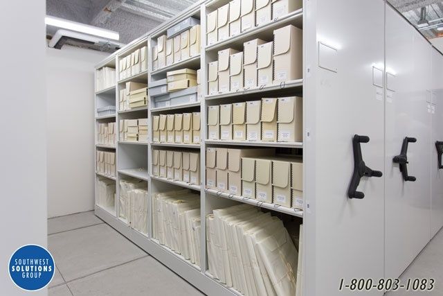 Museumsmagazin mit dicht gefüllten Regalen und verschiebbaren Archivschränken